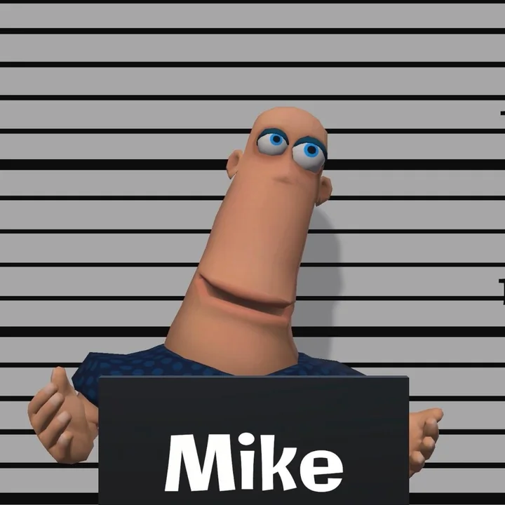 Mike's mugshot: blue eyes and a blue polka-dot shirt, holding a name board.